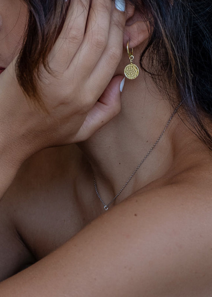 woman with, Phaistos small gold hoop coin earrings by 3rd Floor Handmade Jewellery