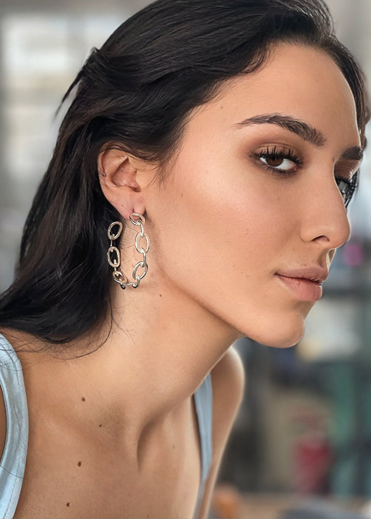 girl in profile wearing silver plated looped hoop earrings