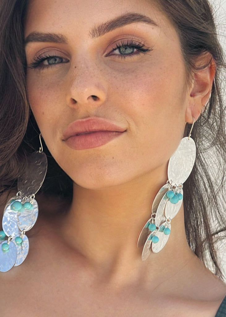 close up to a girl's face wearing the Radia drop earrings