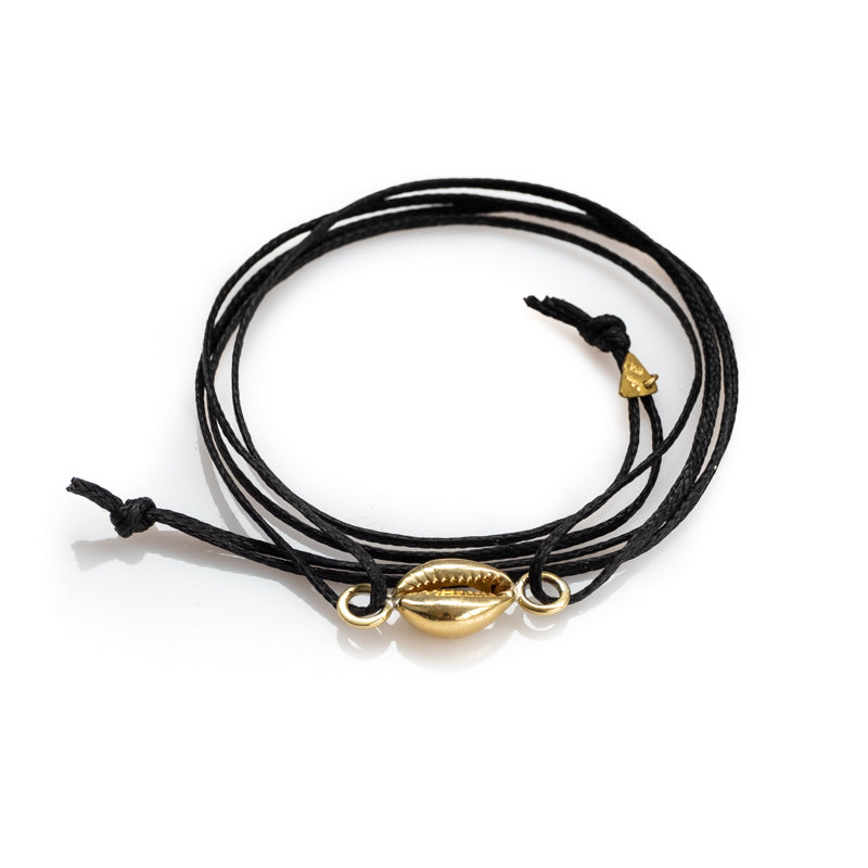 Seashell. Black, leather cord bracelet, with a gold colored seashell. By 3rd Floor Lab
