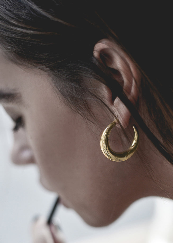 girl with gold diaz earrings