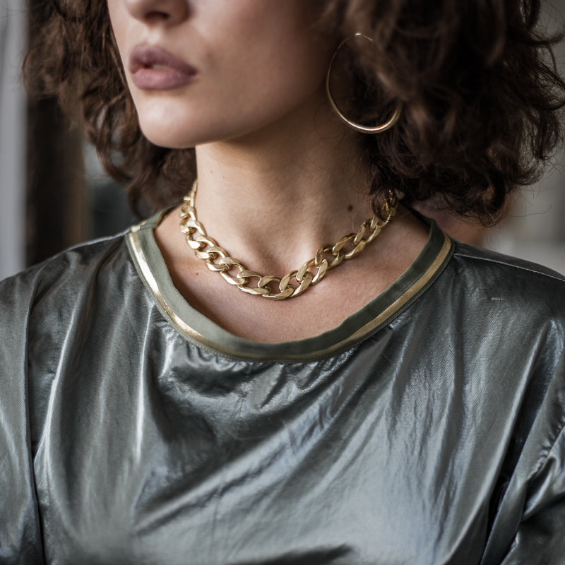 Shot of a woman's head/neck with Bilboe gold necklace. Handmade in Athens by 3rd Floor Workshop
