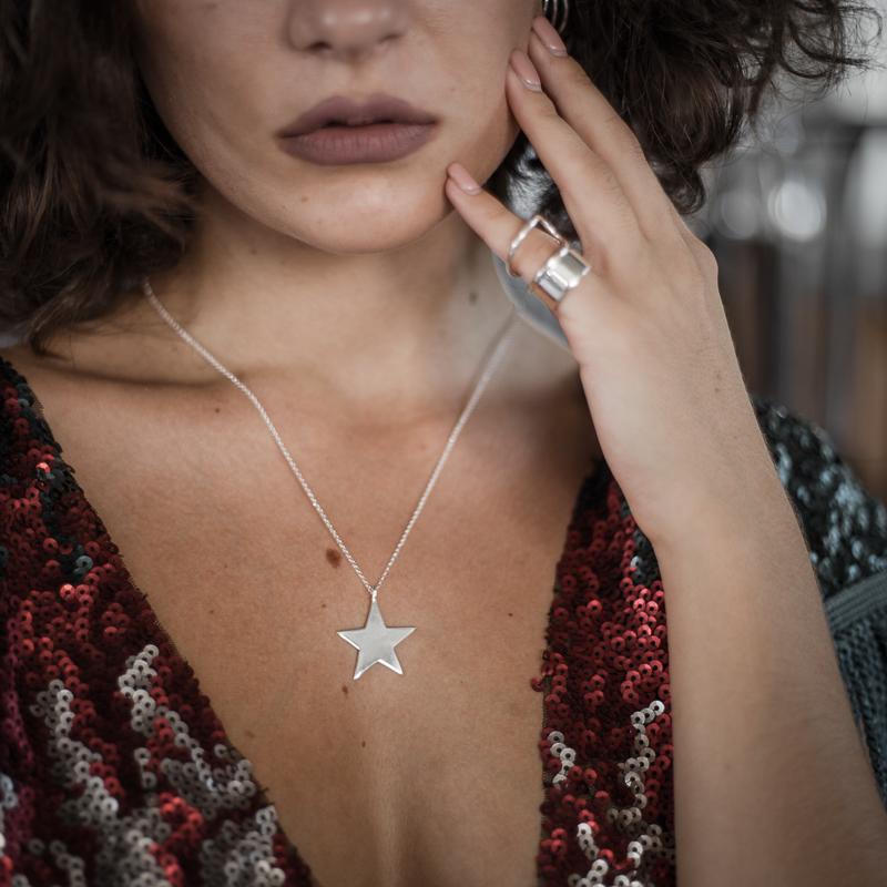 girl holding her face, wearing Vega. Handmade, silver plated 925 silver, star pendant, by 3rd Floor Handmade Jewellery