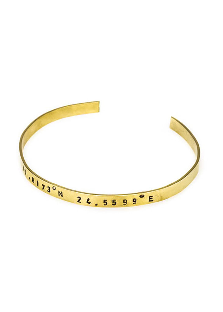 Gold plated adjustable bracelet stamped with earth's longitude and latitude coordinates