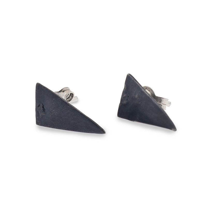 Pair of black, scalene shaped earrings, on a completely white surface